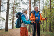 © Юлия Завалишина - Hiking tourism adventure. Senior couple man woman enjoying outdoor recreation hiking in forest. Happy old people backpackers hikers enjoy walking hike trekking tourism active vacation beauty of nature
