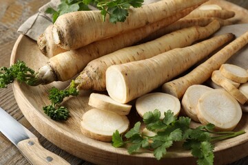 Wall Mural - Parsley roots and leaves with knife on wooden table, closeup