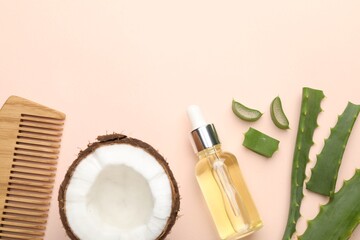 Wall Mural - hair treatment. cosmetic product, comb, coconut and aloe leaves on beige background, flat lay. space