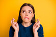 © deagreez - Close up photo cute terrified attractive girl with her fingers crossed biting lips in wait of something while isolated with yellow background