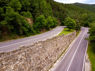 Fototapete - Aerial view of a road in the middle of the forest.