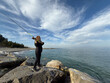 © Sunny studio - Young happy woman is fishing at sea during spring vacation