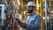 © Koplexs-Stock - A worker examining the machinery with a digital tablet device