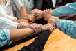 © InfiniteFlow - Multicultural business people holding hand together in circle. Unity teamwork in office business workplace. Diverse ethnic office worker engaged in team building. Meticulous