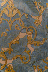 Wall Mural - a close-up of an elegant wallpaper or textile with intricate blue and gold floral patterns. the rais