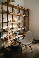 Poster - Creating ceramics ware with own hands. Shelf with handmade clay cups and plates in the pottery studio.