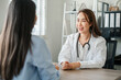 © Satori Studio - Female doctor in a white coat consulting with a patient in a modern office, conveying professionalism and care.