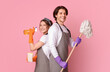 © Prostock-studio - Professional Cleaning Service. Portrait Of Smiling Man And Woman With Household Tools In Hands Standing Back To Back Over Pink Studio Background