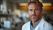 © huiying - Focused male scientist in lab coat embodies dedication to scientific discovery.