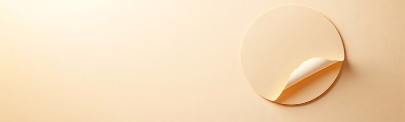 Poster - Peeling circular sticker on a soft beige background, creating a subtle texture.