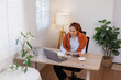 © David - Happy young asian woman accountant working documents on laptop and phone desk using calculator for calculate finance report in home office