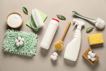 Wall Mural - Different cleaning products, tools, cotton flowers and leaves on beige background, flat lay