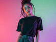 © DOUGLAS - woman in casual t shirt stands confidently against colorful gradient background