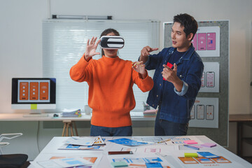 Wall Mural - asian software developers testing virtual reality application and experiencing metaverse in modern o