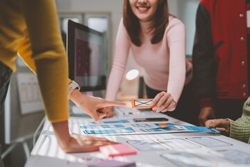 Wall Mural - user experience designers are working together to develop a mobile application by choosing the right