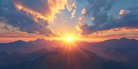 Wall Mural - Vibrant sunset over mountains with golden rays illuminating the clouds and silhouetted peaks creating a serene and breathtaking landscape scene.