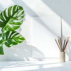 Poster - Minimalist Workspace Aesthetic Monstera Leaf and Art Supplies on White Desk - Creative Company Branding and Productivity in Modern Design Studios