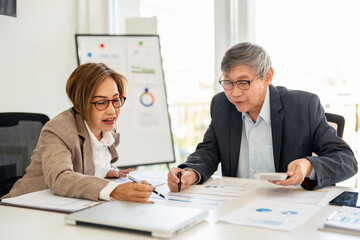 Wall Mural - Meeting a team of businessmen, Executives and accountants meeting about the company's revenue graph in the office with laptops and calculator, Finance concept.