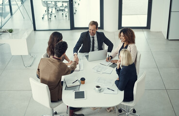 Poster - Teamwork, meeting and handshake with business people in office for success, spreadsheet or budget proposal. Revenue report, market forecast or shareholder approval with above of employees in workshop