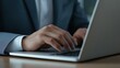 © michnik101 - Businessman hands typing on laptop keyboard. Digital work and corporate productivity.