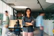 © NDABCREATIVITY - Confidence and happy smiling business woman portrait with blur motion background of his colleague