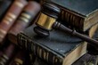 © pingpao - A gavel rests atop a stack of vintage law books, symbolizing justice and the legal profession. This image captures the essence of law and order.