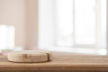 Wall Mural - empty podium on wooden table with blur room and window interior background for design mockup placeme