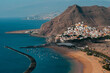 © Pavel - Aerial view of a coastal town with a sandy beach and blue waters in Tenerife