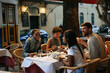 © bernardbodo - Friends enjoying dinner together at outdoor restaurant in Lisbon