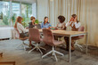 © bernardbodo - Businesswomen sitting down for a meeting inside of the glass office