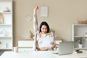 Wall Mural - Happy young woman with refund form at table in room