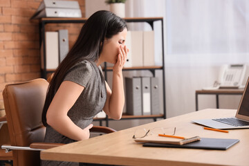 Poster - Sick businesswoman suffering from bellyache at table in office