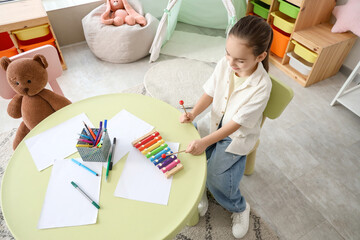 Poster - Cute girl playing xylophone on table at home