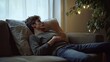 © Jorda - Stomach pain felt by a young man lying on a couch, holding his stomach. Featuring discomfort and recovery