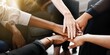 © Rawpixel.com - Diverse group of business people's hands showing unity and teamwork. Business people's hands of different ethnicity coming together in a display of teamwork and unity. Diverse hands for teamwork