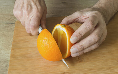 the fruit of the orange is cut into two parts