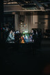 © qunica.com - A group of business coworkers working together on a project in an office during nighttime, creating a productive and focused atmosphere.
