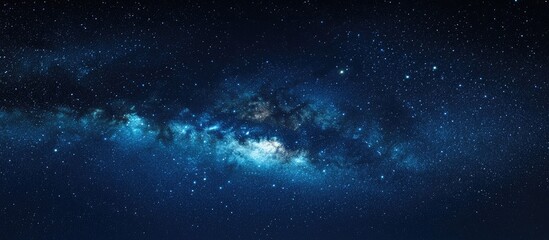 Wall Mural - Starry night sky over Joshua Tree National Park showcasing the vibrant Milky Way with deep blue hues and scattered bright stars across the frame.
