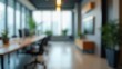 © useful pictures - Blurry image of a large office space with a few potted plants