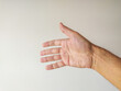 © SolaruS - Closeup of a mans hand reaching out, palm up, against a neutral background.  Ideal for concepts of help, giving, receiving, connection, or generosity.