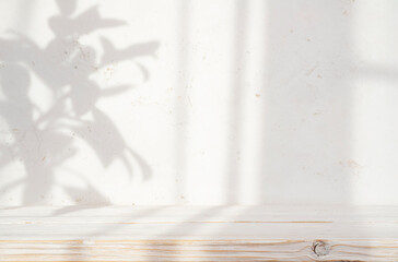 Wall Mural - blur cream white cement wall with soft beautiful dappled sunlight leaves shadows background for prod