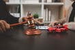 © kamiphotos - a lawyer is explaining the details of a car insurance policy to the car owner before she signs it, a lawyer explains to his client what will happen if she doesn't get car insurance