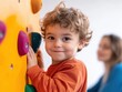 © vinod - boy climbing on climbing wall in gym