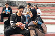 © EFStock - Asian University students studying together outdoors in the college campus Stairway. Diversity in Indonesia