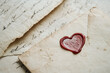 © wolfhound911 - Illustration of a love letter with delicate handwritten script and a heart shaped wax seal. The vintage paper and soft colors evoke feelings of romance and sentimentality, perfect for a heartfelt
