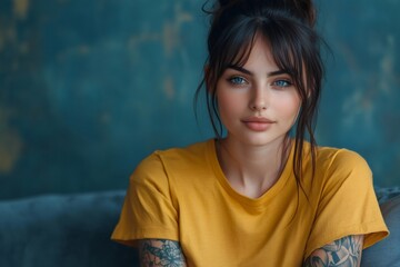 Poster - Beautiful tattooed influencer posing with yellow t shirt and blue background