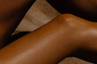 © Mirrorstudio - Close-up of sun-kissed female skin in sunlight on sand background. Skin care, sun protection