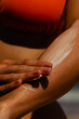 © Mirrorstudio - Young hispanic female applying sunscreen on arm at beach. Skin care, sun protection