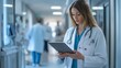 © liliyabatyrova - A dedicated doctor engages with a patient, utilizing a tablet to share important medical insights. This occurs in a busy hospital corridor, reflecting the pace of modern healthcare