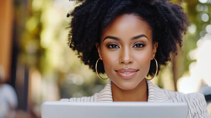 Canvas Print - Professional African American businesswoman working on tablet outdoors, embodying corporate success with urban background